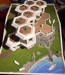 Model of a unique home with hexagonal roofs, and a stunning ocean view.