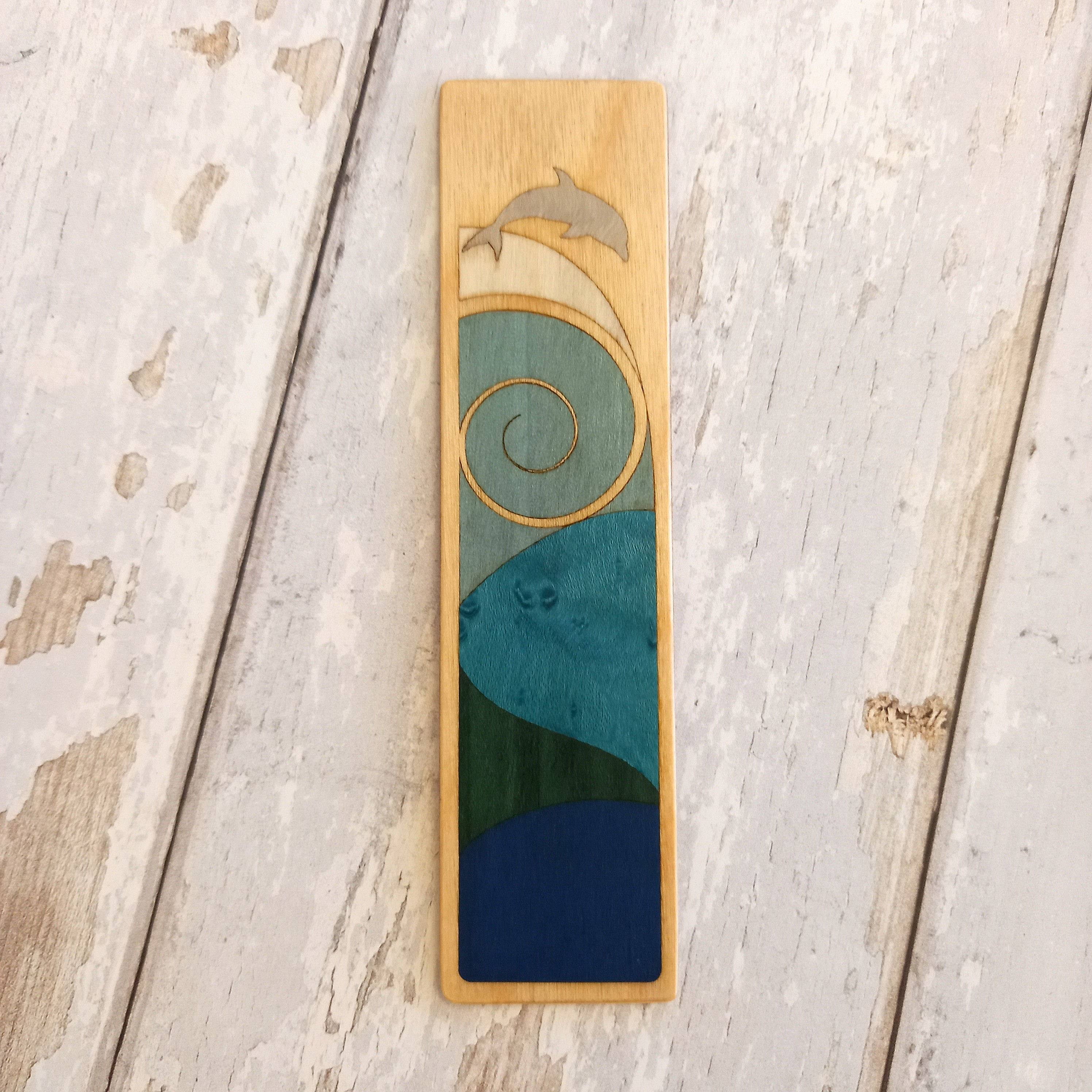 jumping dolphin wooden bookmark design in greens and blues