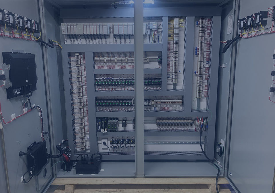 Electrical cabinet interior, highlighting structured wiring and mounted electrical devices.