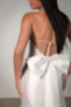 Back detail of Stella York 8159 wedding dress featuring pearl-beaded straps and oversized satin bow.