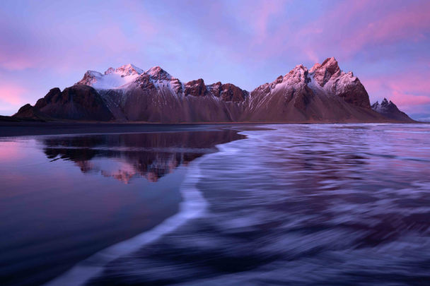Stokksnes on Iceland in purple light of the sinking sun.