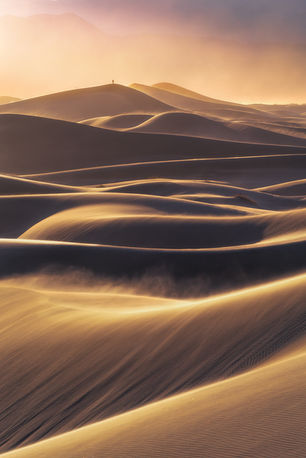 Photographer on a distant sand dune in Death Valley.