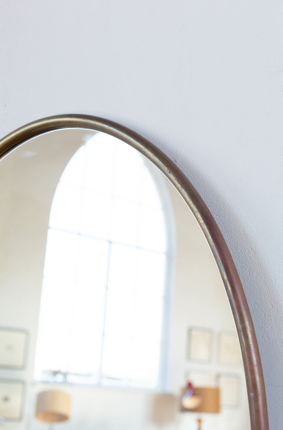 Thumbnail: A large brass-framed oval mirror from Italy, C1950.