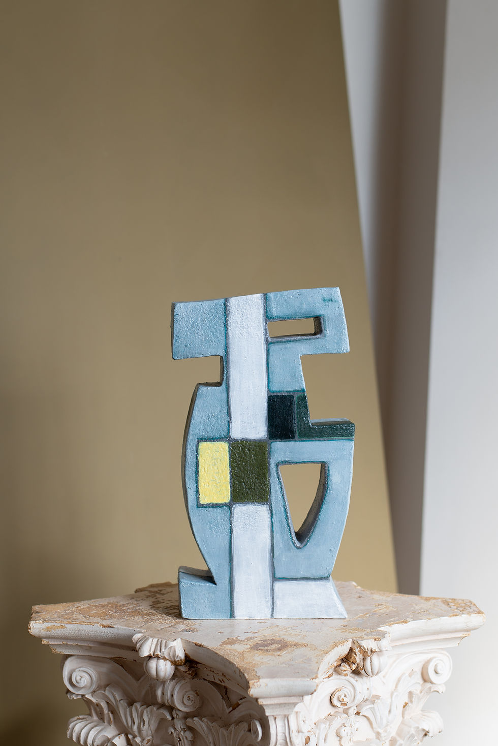 This sculptural piece is made using a hand-built slab construction, in under-glazed bisque fired earthenware.