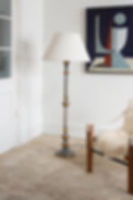 A turned wood floor lamp in a church candelabra style with distressed grey and gilt finish.