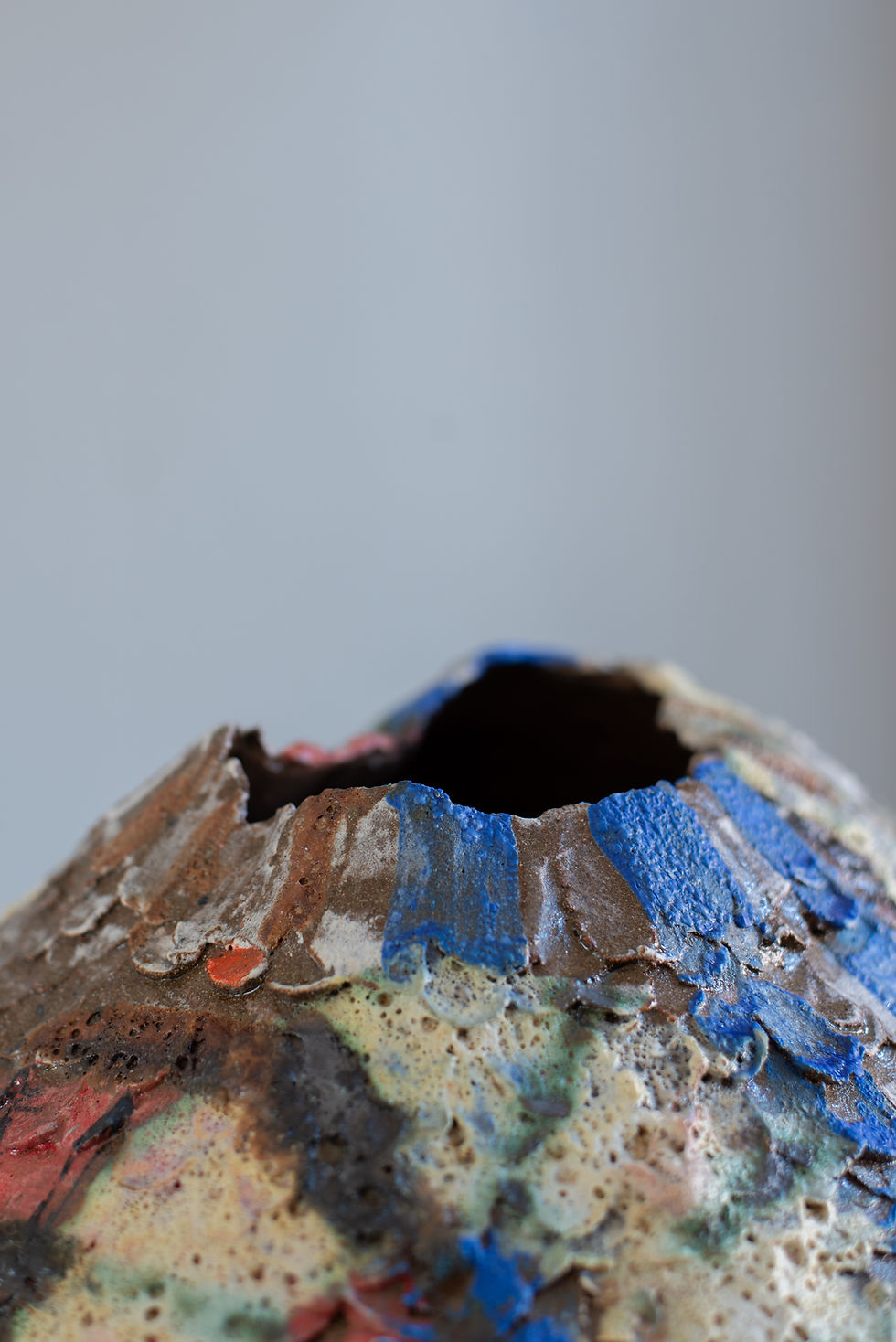 A stoneware sculptural vessel with glaze and stains by artist Linda Lencovic.