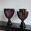 Thumbnail: A pair of heavy hand-painted stone French urns. In Oxblood and black.