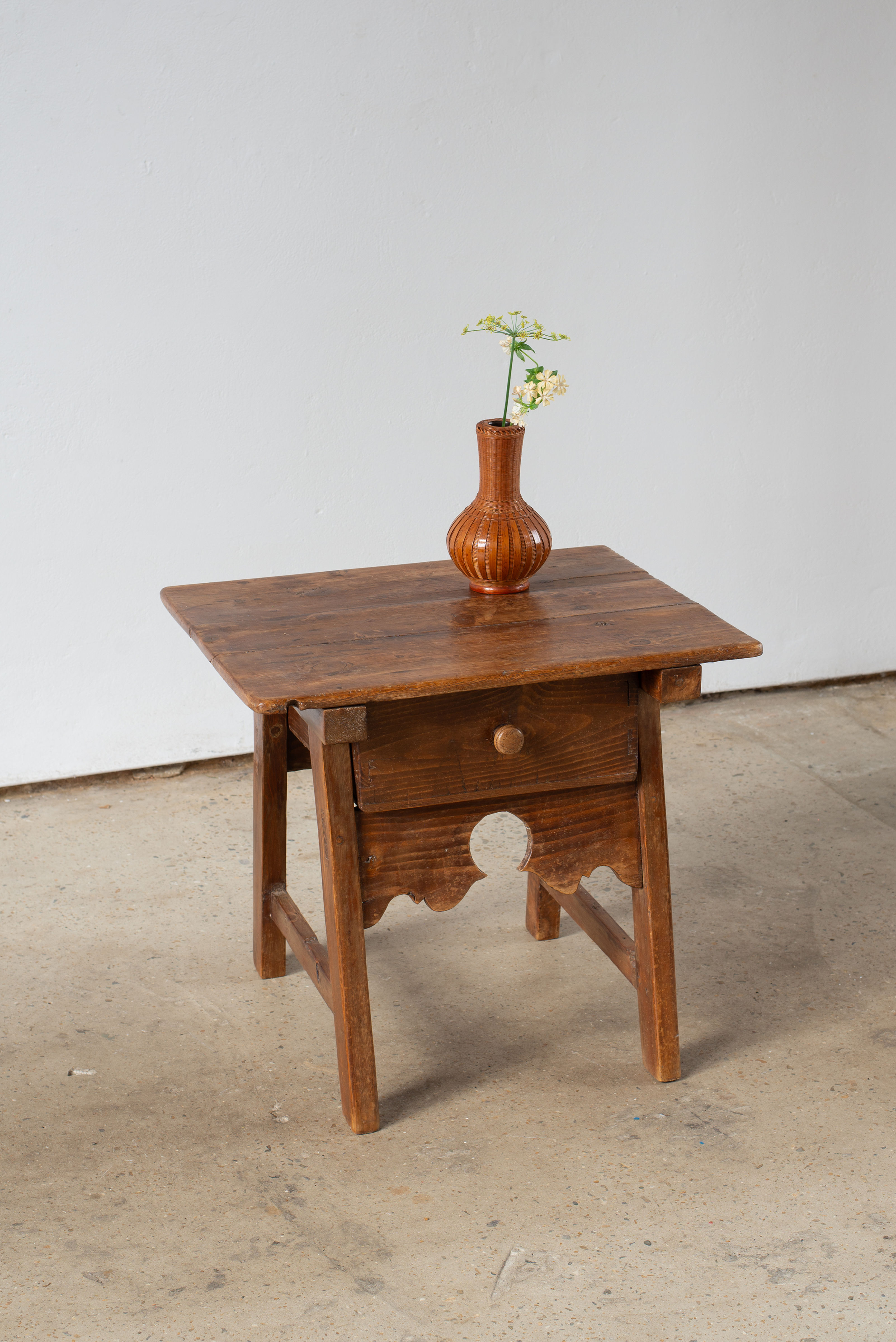 A 19th-century Spanish side table crafted from chestnut wood.  It has a generously sized drawer which sits beneath the plank