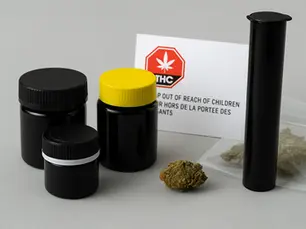 Child-resistant cannabis packaging in Canada including black PET jars, pop-top tube, and resealable mylar bag with Health Canada warning label.