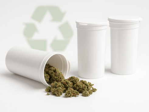 White recyclable pop-top tubes spilling cannabis buds on a white surface with a faint recycling symbol behind them.