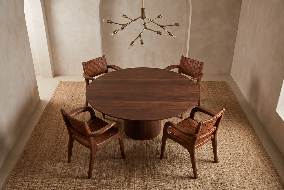 Top-down view of four curated dining chairs arranged in balanced radial symmetry around a circular dining table.