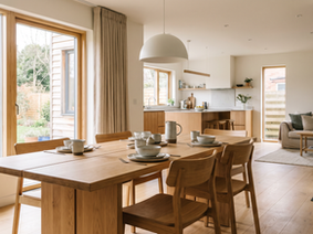 Natural solid wood family dining table set in a luminous modern dining room.