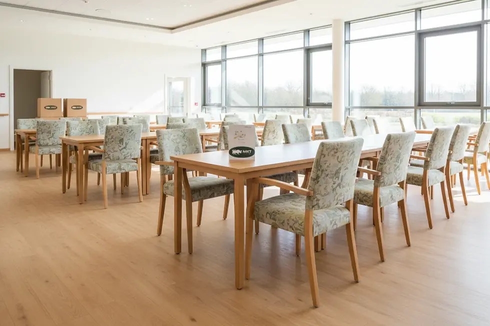 Elegant contract dining furniture inside a modern senior care facility dining hall.