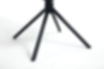 Close-up of black metal spider-style dining chair legs showing stable four-point base