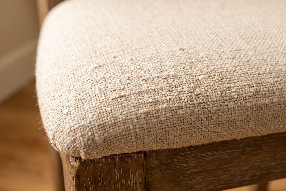 Close-up of textured cotton-linen upholstery fabric on a dining chair seat