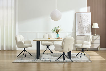 Minimalist dining room with a light wood dining table and four cream upholstered swivel dining chairs with black metal star bases on a patterned rug.