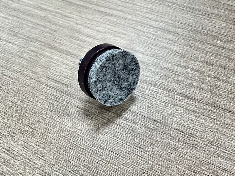 Close-up of industrial-grade screw-in felt glide with high-density felt designed to prevent scratches on parquet and hardwood floors
