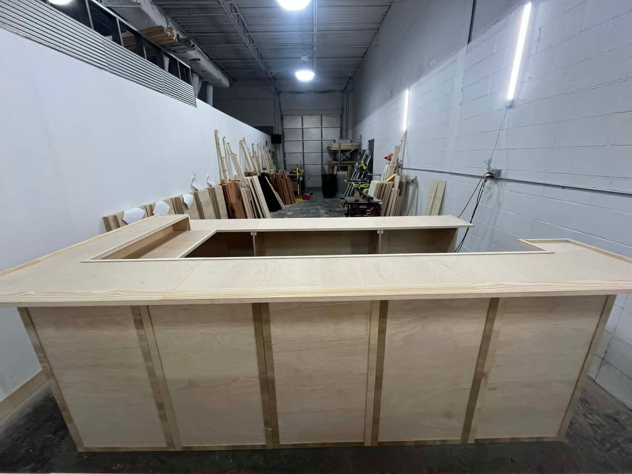 10 foot home bar with connected back, upper and lower shelving, 2 level top