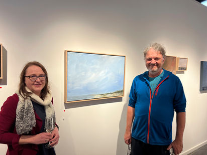 Artist celebrating  with the buyer of her painting