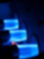 Three natural gas burners firing brilliant blue flames into an active furnace, the core of
