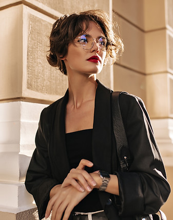 trendy-woman-with-wavy-hairstyle-and-red-lips-posing-outside-brunette-woman-in-dark-jacket