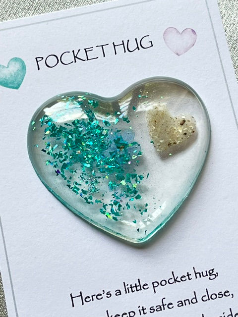 Thumbnail: Teal pocket hug with a forget me not and an ashes heart