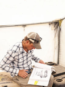 A man reading a book on archaeology