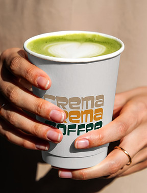 Matcha Woman Holding in a Paper Cup Crema Crema.jpg