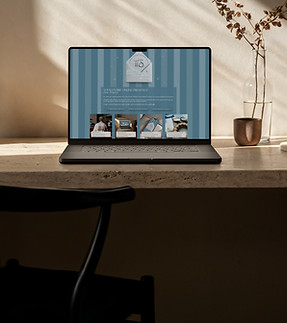 Laptop on Boucle Sofa showing Teddy Lennox Social Homescreen to demonstra web design.jpg
