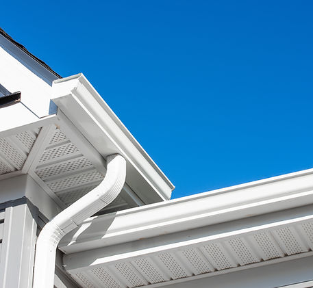 Colonial white gutter guard system,  soffit providing ventilation to the attic, with gray 
