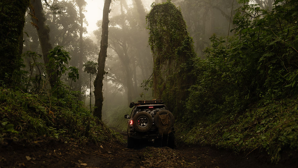 4x4 vehicle driving through misty cloud forest to Acatenango Volcano luxury glamping camp Guatemala