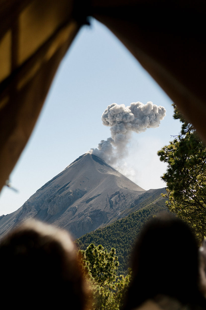 iew of erupting Fuego Volcano framed by tent opening at Acatenango Basecamp Guatemala