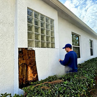 Stucco opened to reveal hidden moisture damage behind the wall