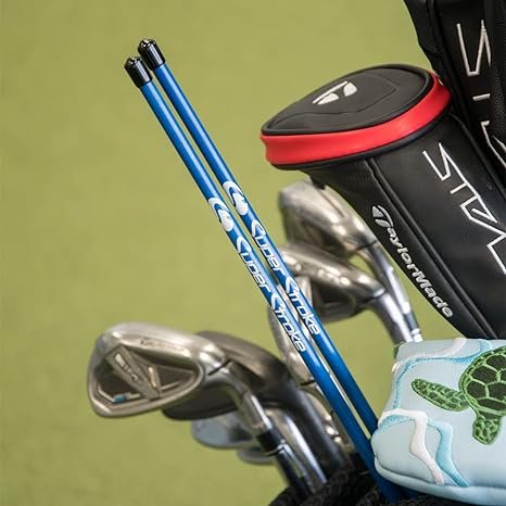 SuperStroke Alignment Sticks tucked into a golf ball along with golf irons, golf drivers and two taylormade stealth golf headcovers