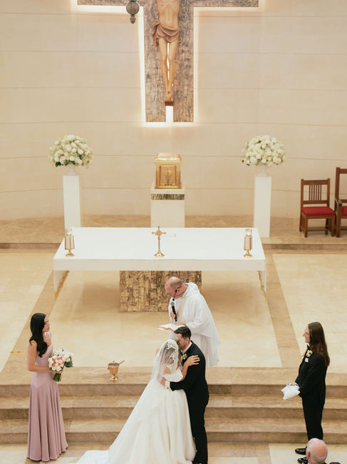 Bride and groom kissing at Stella Maris Church