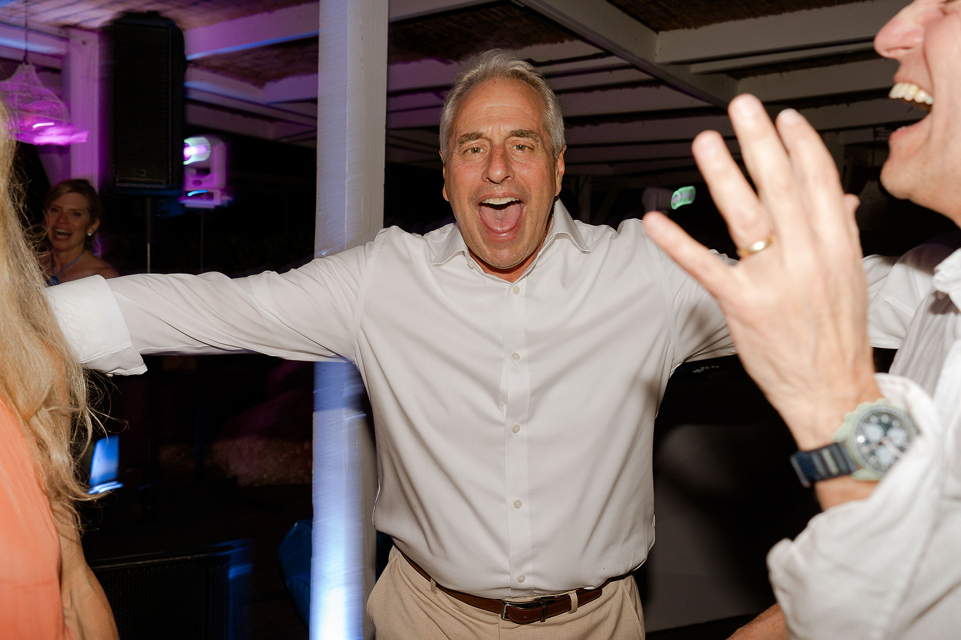 Wild reception dancing at a wedding with wedding guests