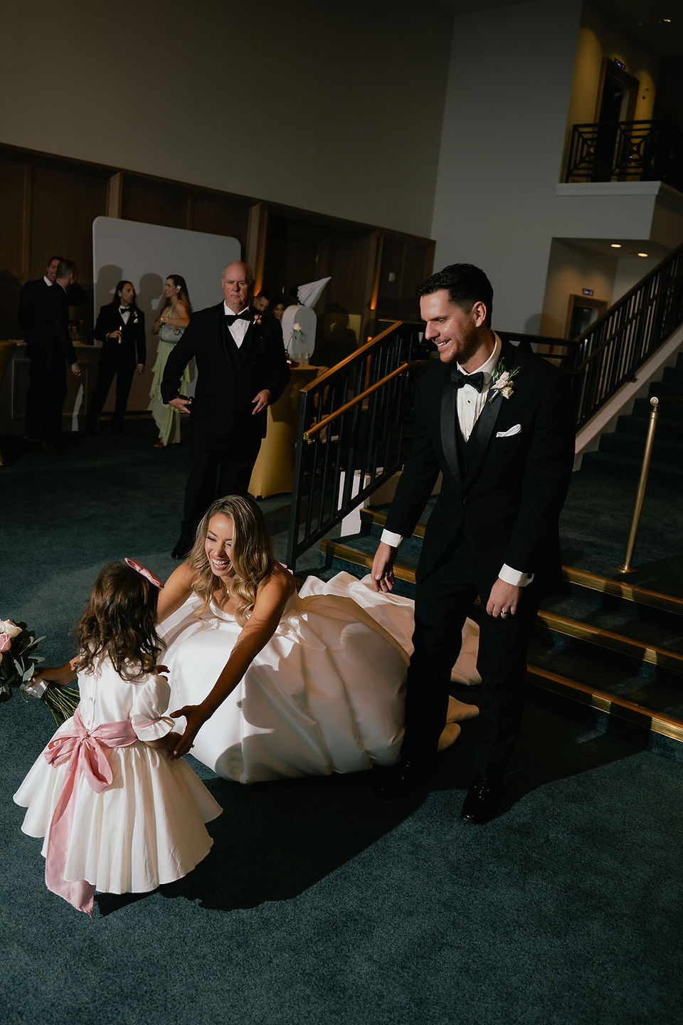 happy couple entering the event at Bride standing in the middle of her bridesmaids wearing soft pink pastel gowns at the beachfront terrace of the San Juan Marriott Resort and Stelaris Casino