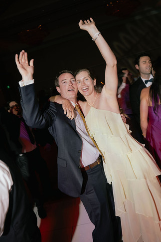 Wedding guests partying with their arms up in the air