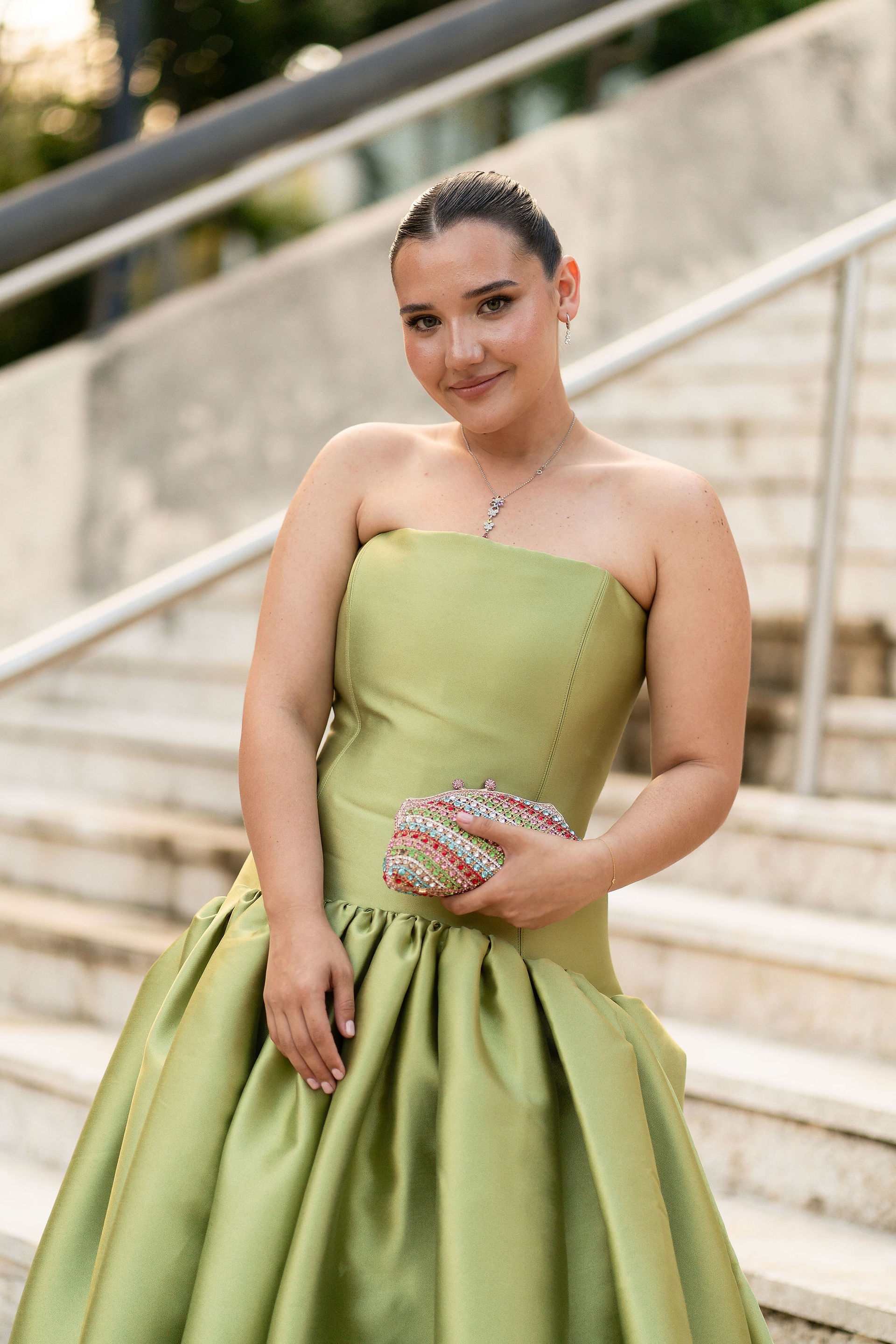 portrait of woman wearing a green gown and  enjoying at El Museo de Arte de Puerto Rico at a wedding