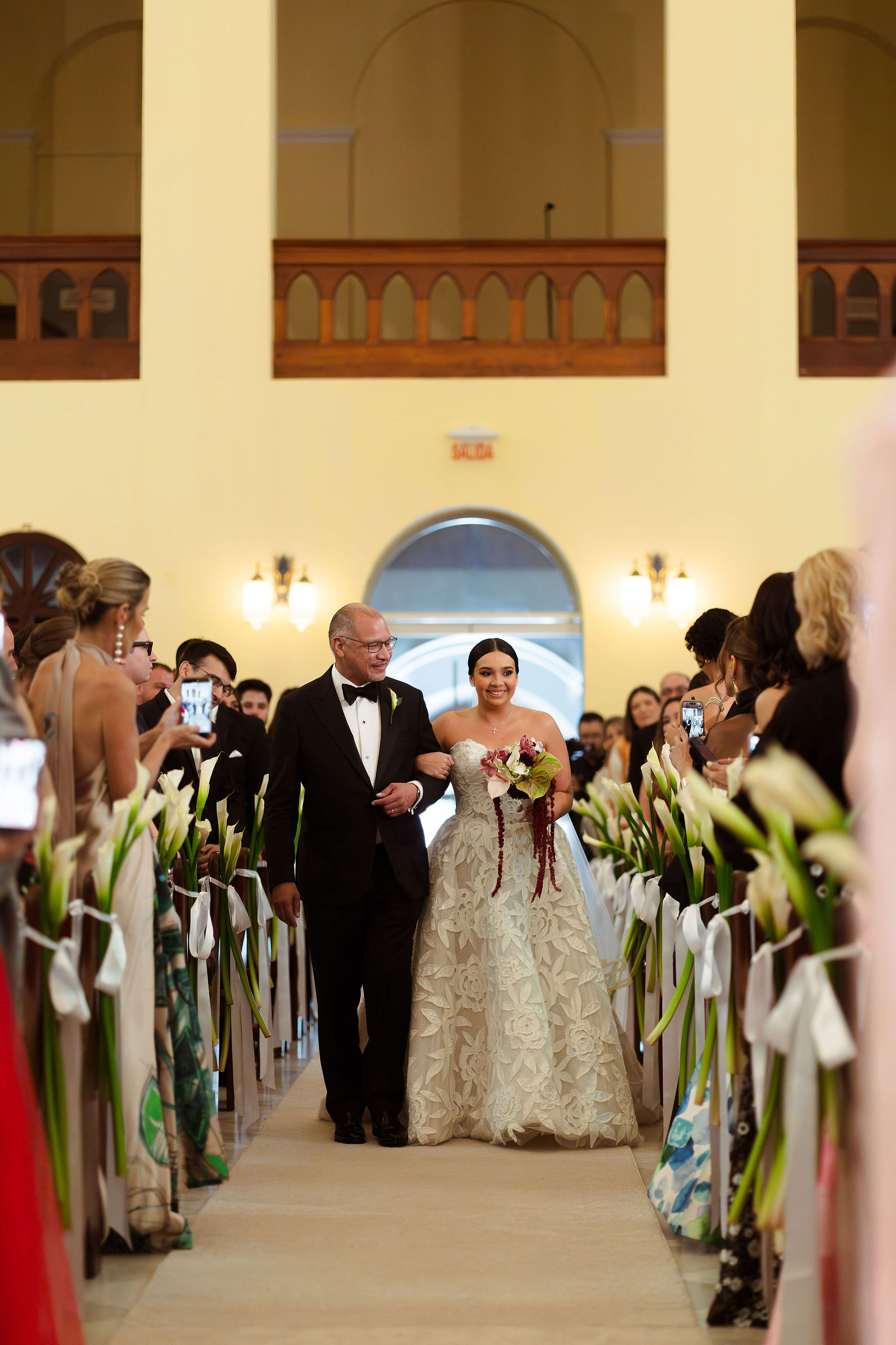 Bride walking down the isle in Puerto Rico church