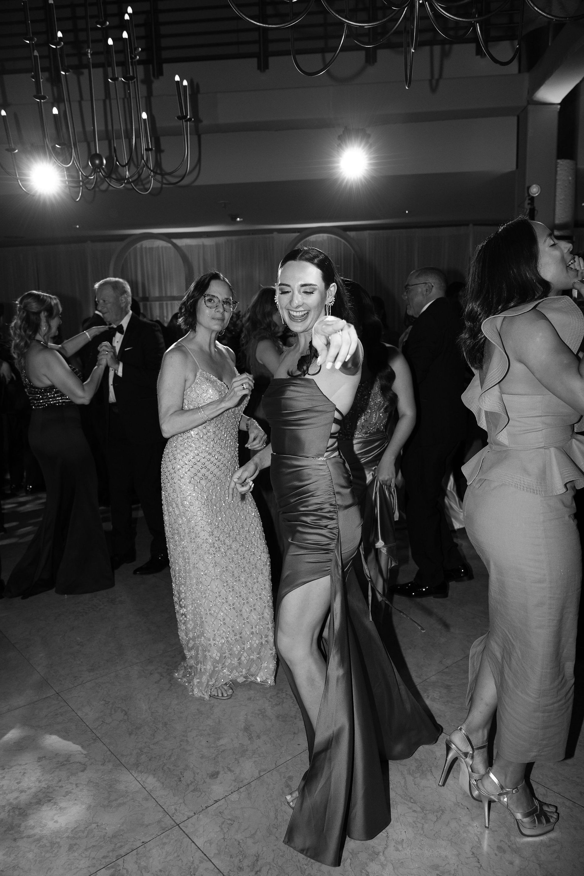 Female wedding guest dancing, black and white portrait at El Museo de Arte de Puerto Rico 