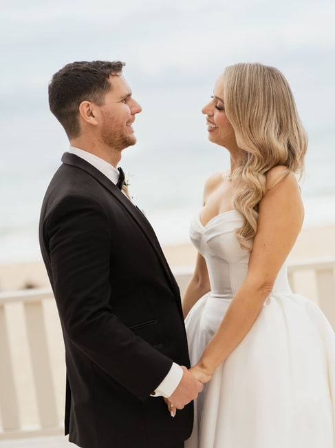 Bride and groomlooking at eachother at the beachfront terrace of the San Juan Marriott Resort and Stelaris Casino