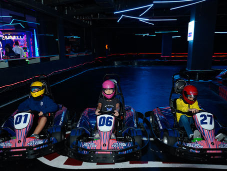 3 friends enjoying go karting in gurgaon at the pink falcon