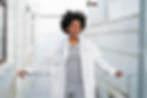Modern nurse leaning against a railing contemplating the future