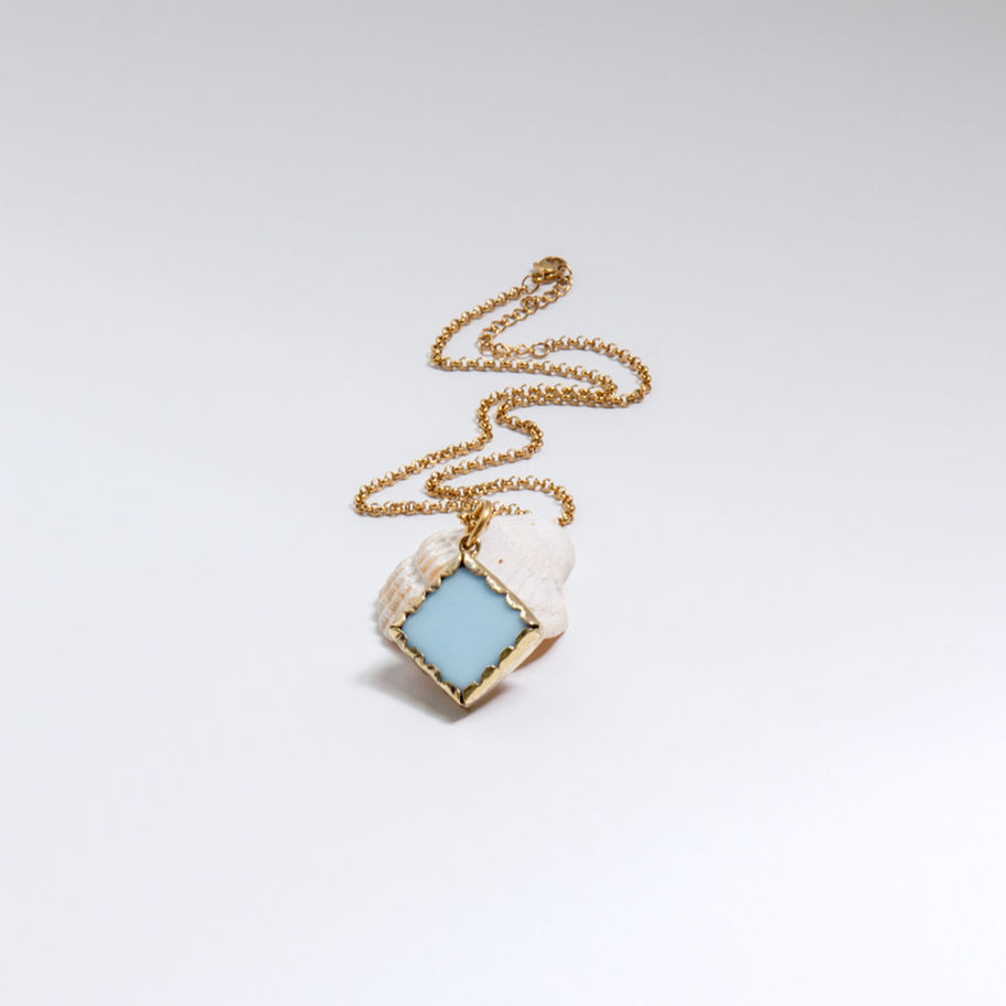 Gold necklace with light blue square pendant