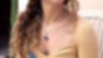 Woman wearing purple square pendant necklace