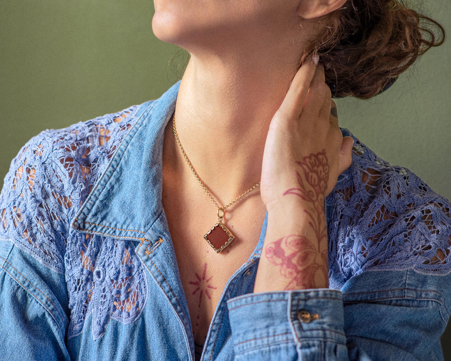 Woman wearing Comets In The Sea Earrings and a necklace