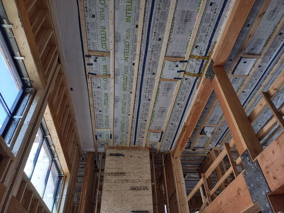 Interior construction view showing advanced roof framing, Intello Plus vapor retarder, and timber structure at the Victorian-inspired passive house designed by Held Architecture in Davidson, North Carolina.