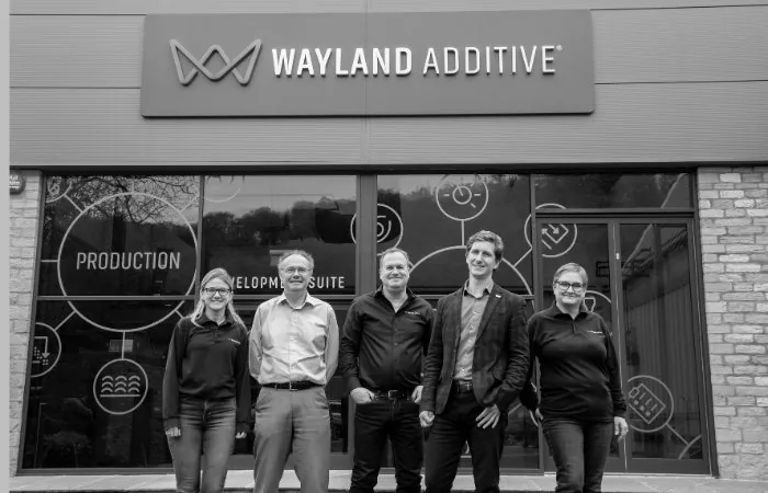 The Wayland Additive team outside the company’s production building.