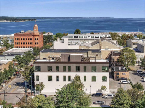The Penthouses at 111 State are the pinnacle of luxury in Traverse City. Overlooking Rotary Square Park, steps from Grand Traverse Bay, the residences feature private elevators that open directly into the foyer, dedicated rooftop terraces with pergolas, and parking garages with abundant storage. Unparalleled privacy on a premier downtown corner, with direct access to the city's best shopping, dining, marinas, trails, and sandy beaches. Sales begin Spring 2025.
Architecturally, the penthouses are designed with floor-to-ceiling windows that wrap three sides of the home, capturing expansive views and flooding the oversized interiors with natural light. Spanning nearly 3,500 SF of private interior and exterior space, each residence has 5 bedrooms, 3 bathrooms, library, open kitchen, dining room and great room.
Meticulously curated interiors feature a bespoke design package with finishes that include white oak, natural stone, premium marble, handcrafted cabinetry, high-end integrated kitchen appliances, custom hardware and lighting fixtures. Every element, from architectural precision, exquisite craftsmanship, to the finest interior finishes, reflects a dedication to an extraordinary residential experience.
